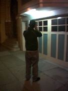 My phone camera takes better night shots. Here's Dave taking a picture with my Nikon...