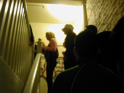 Top of the stairs, we wait in line to get in.